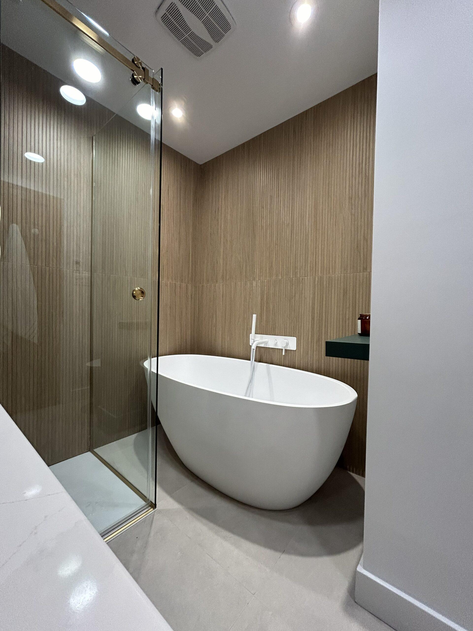 Salle de bain design Blainville baignoire autoportante mur texturé et douche en verre moderne